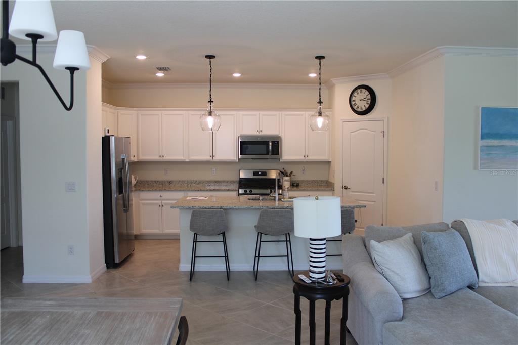 6647 Clairborne Lane Bradenton, FL 34211 - Photo 5 of 39 a kitchen with a refrigerator and a stove top oven