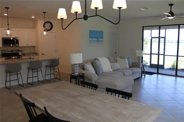 a living room with patio furniture and a wooden floor