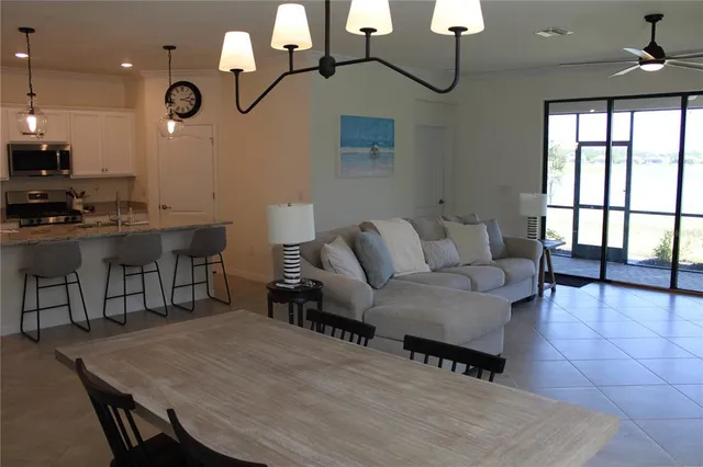 a living room with patio furniture and a wooden floor