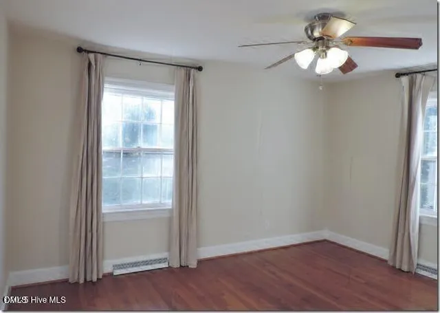 a view of a small space with wooden floor fan and window