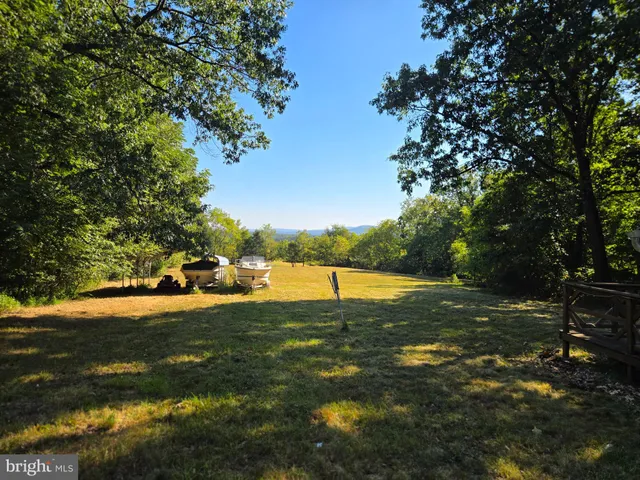 a backyard of a house with yard and outdoor seating