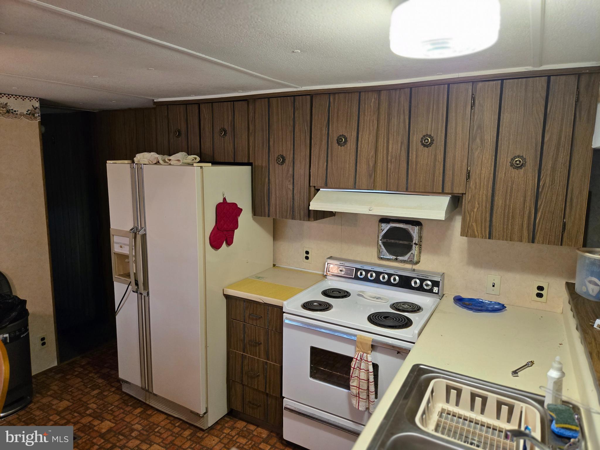 6721 Old Plank Road Broad Top, PA 16621 - Photo 5 of 18 a kitchen with a refrigerator and a stove