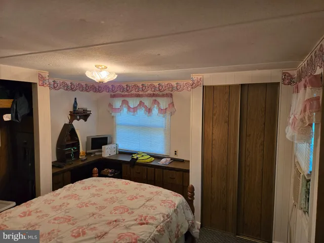 a bed room with a bed and a chandelier