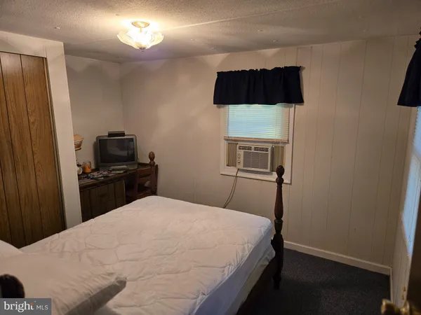 a bedroom with a bed and a television