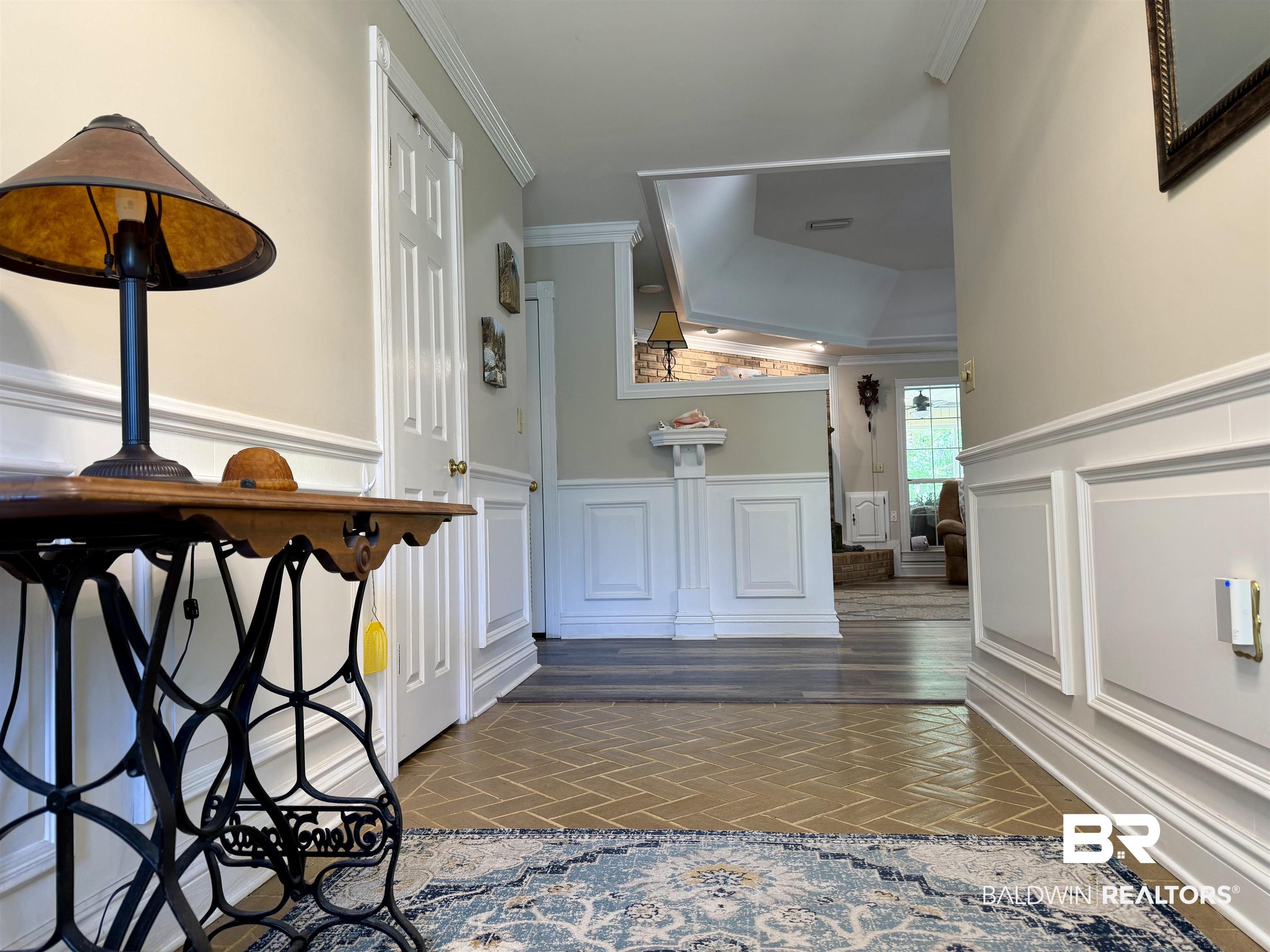 2944 Appleton Road Brewton, AL 36426 - Photo 3 of 65 Hallway featuring ornamental molding, wainscoting, and dark wood finished floors