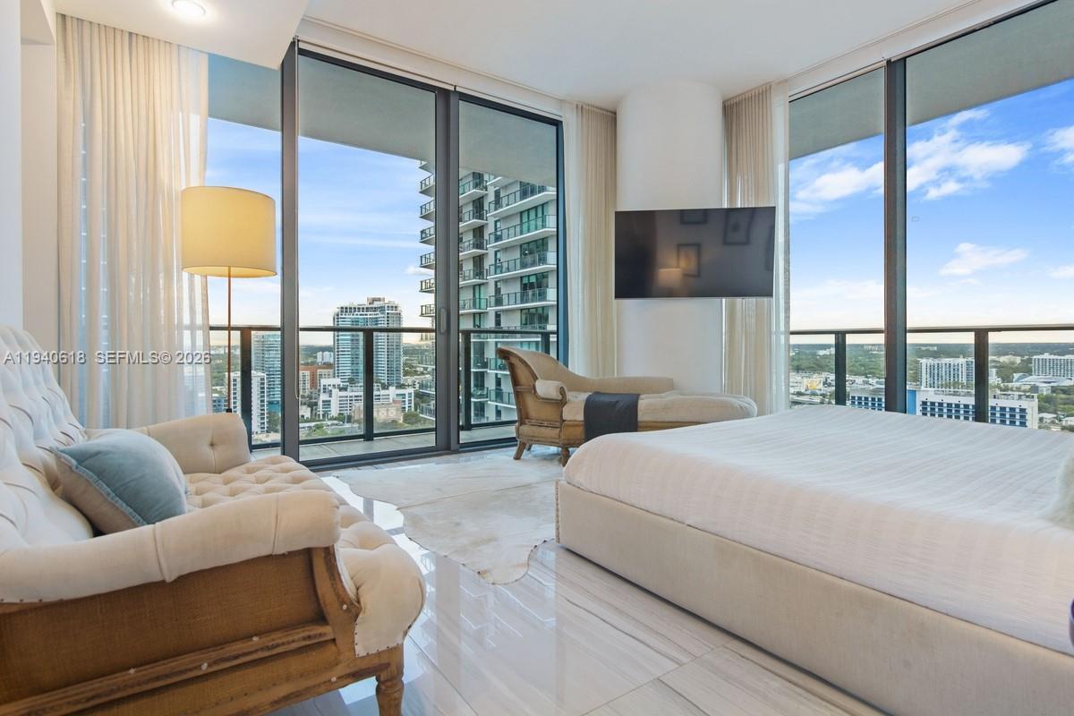 480 Northeast 31st Street, Unit 2307 Miami, FL 33137 - Photo 15 of 47 a spacious bedroom with a bed and glass window