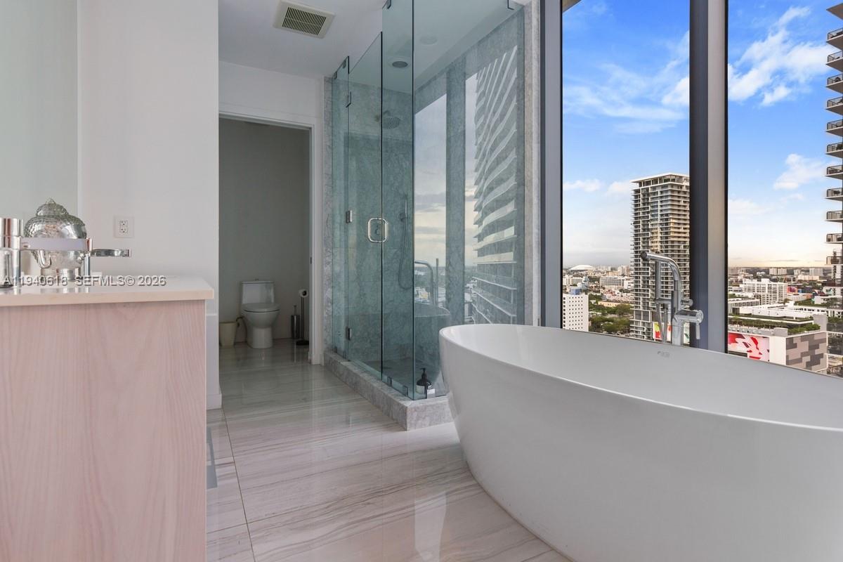 480 Northeast 31st Street, Unit 2307 Miami, FL 33137 - Photo 19 of 47 a bathroom with a sink a toilet and tub