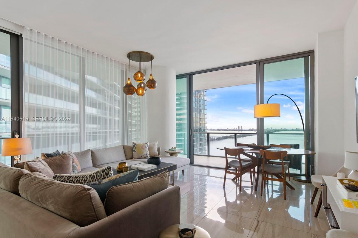 480 Northeast 31st Street, Unit 2307 Miami, FL 33137 - Photo 3 of 47 a living room with furniture and floor to ceiling windows