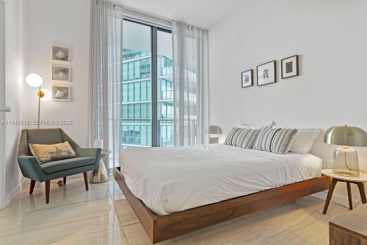 480 Northeast 31st Street, Unit 2307 Miami, FL 33137 - Photo 10 of 47 a bedroom with a bed and a window