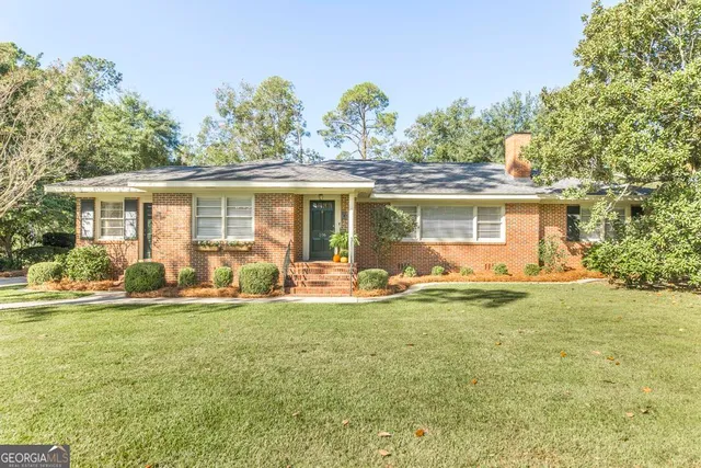 a front view of house with yard and green space
