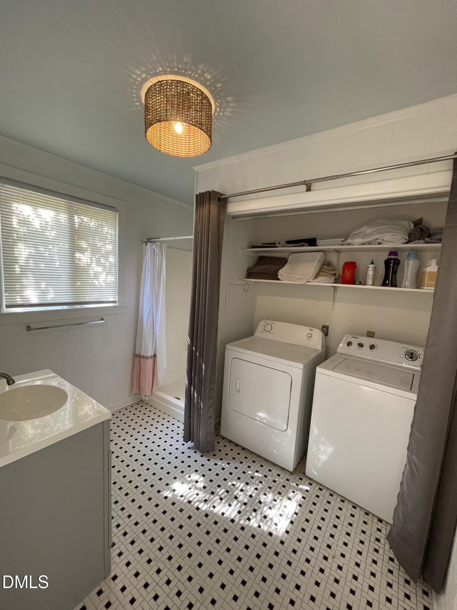 1009 Canterbury Road Raleigh, NC 27607 - Photo 20 of 31 a room with a washing machine and wooden floor