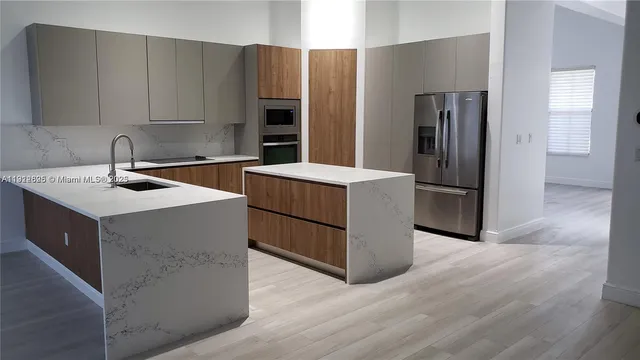 a kitchen with stainless steel appliances a refrigerator and a sink