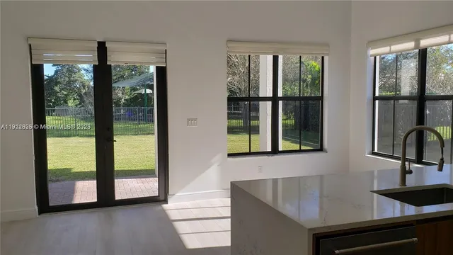 a kitchen with a sink and large window