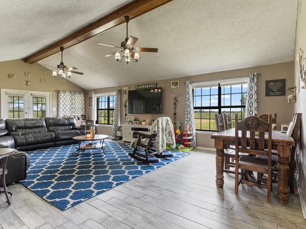 a living room with furniture a fireplace and wooden floor