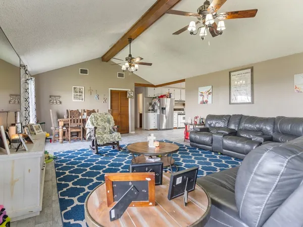 a living room with furniture and a chandelier