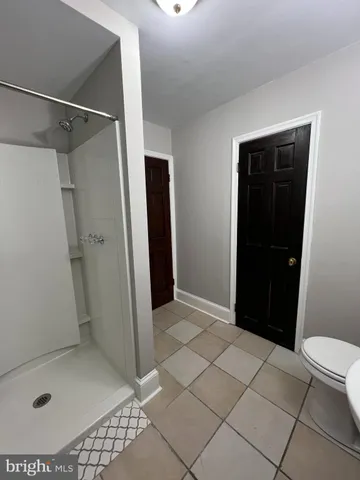 a bathroom with a glass door shower