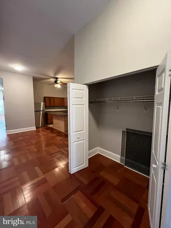a empty room with a fireplace and wooden floor