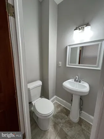 a bathroom with a sink a toilet a mirror and vanity