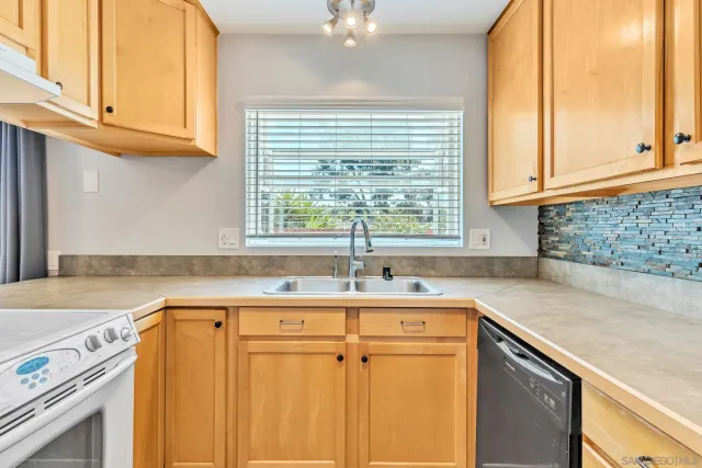 a kitchen with a sink cabinets and window
