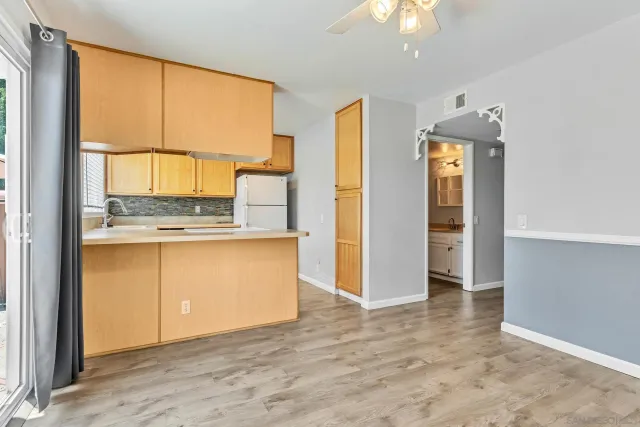 a view of a kitchen with a sink and cabinets