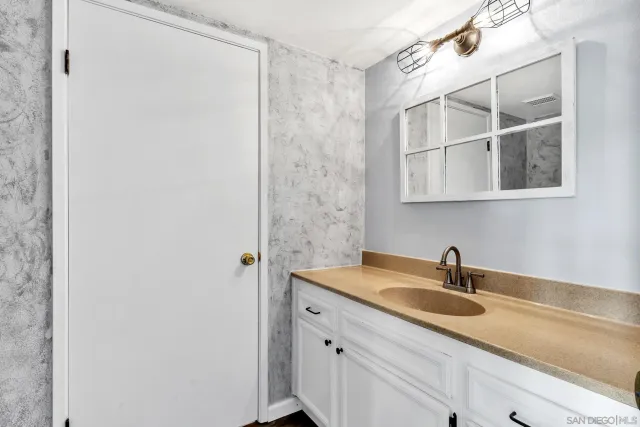 a bathroom with a sink and a white cabinet
