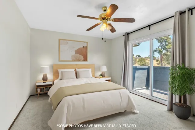 a bedroom with a balcony a bed and a chandelier