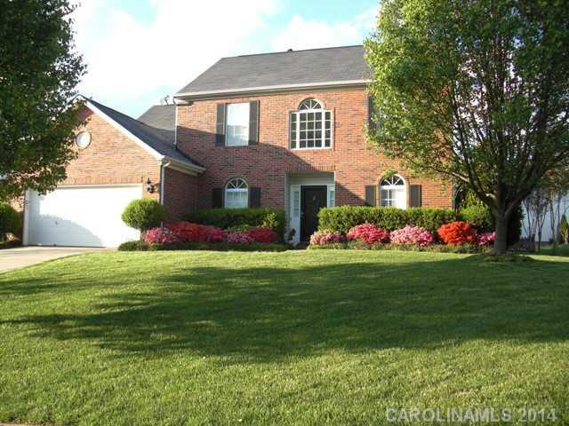 a front view of house with outdoor seating and yard