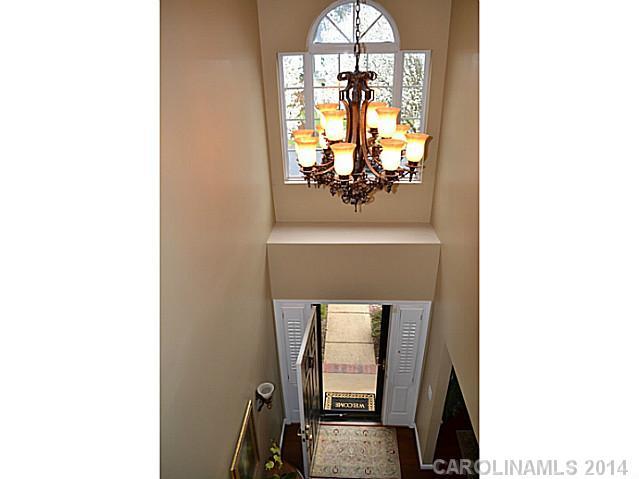 704 West Cheval Drive Fort Mill, SC 29708 - Photo 2 of 16 a view of a hallway with wooden floor and dining room