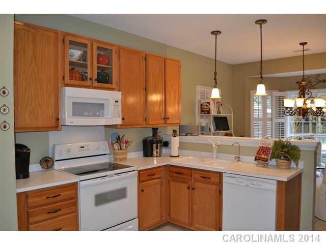 704 West Cheval Drive Fort Mill, SC 29708 - Photo 5 of 16 a kitchen with stainless steel appliances granite countertop a sink a stove and a wooden floor