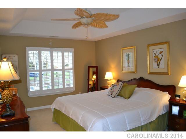 704 West Cheval Drive Fort Mill, SC 29708 - Photo 7 of 16 a bedroom with a bed and a chandelier