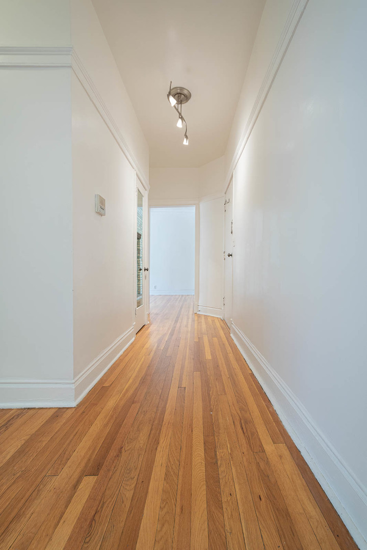 722 West Sheridan Road, Unit 3N Chicago, IL 60613 - Photo 11 of 14 wooden floor in an empty room with a window