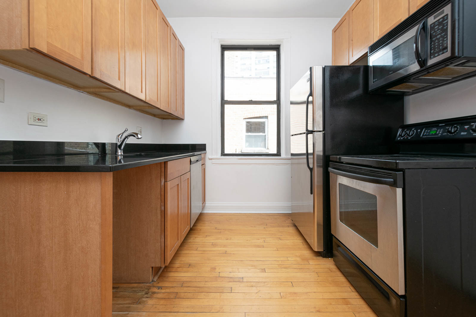 722 West Sheridan Road, Unit 3N Chicago, IL 60613 - Photo 6 of 14 a kitchen with a refrigerator and a sink