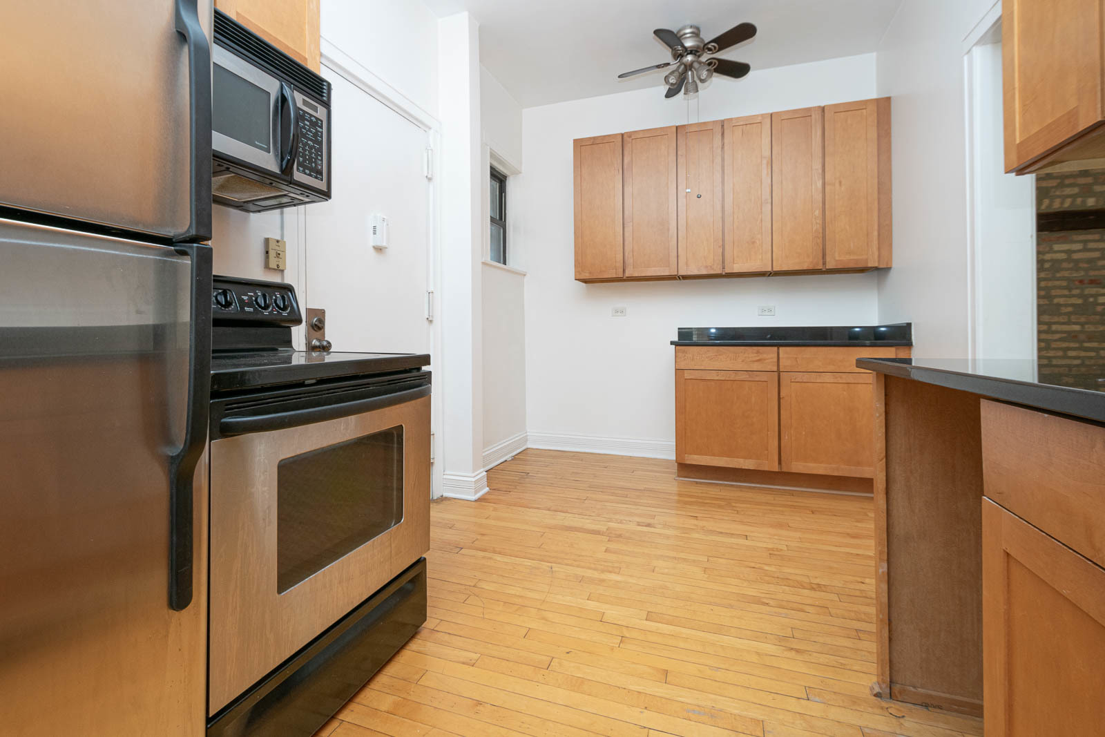 722 West Sheridan Road, Unit 3N Chicago, IL 60613 - Photo 7 of 14 a kitchen with stainless steel appliances granite countertop a stove a sink and a refrigerator