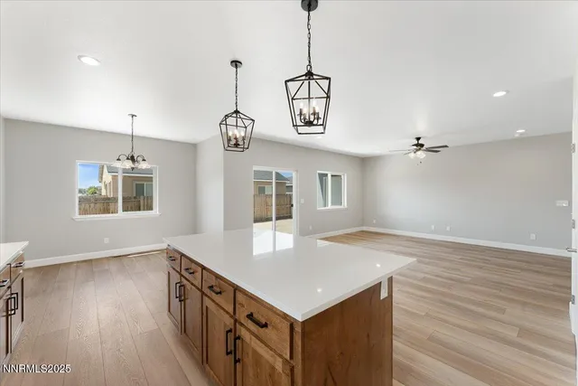 a kitchen that has a microwave a stove and wooden floor