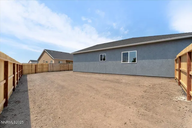 a view of a house with backyard and trees