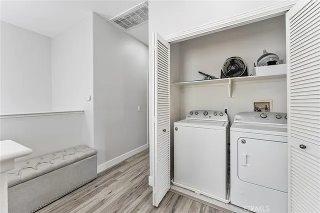 a view of washer and dryer with kitchen in the background