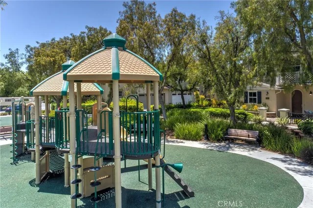 a view of a chair and table in backyard of the house