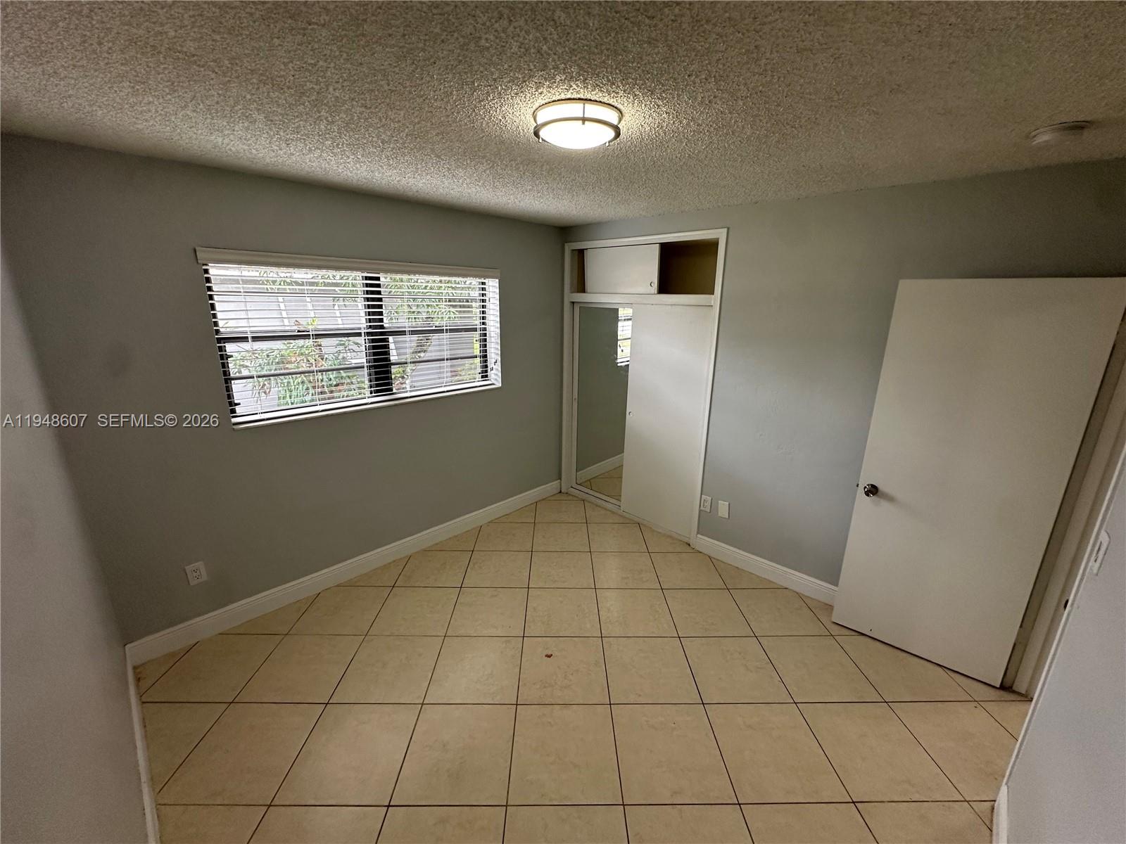 7860 Southwest 16th Street Miami, FL 33155 - Photo 16 of 32 a view of an empty room with a window