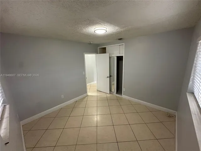 a kitchen with stainless steel appliances granite countertop a refrigerator a stove a sink a washer and dryer