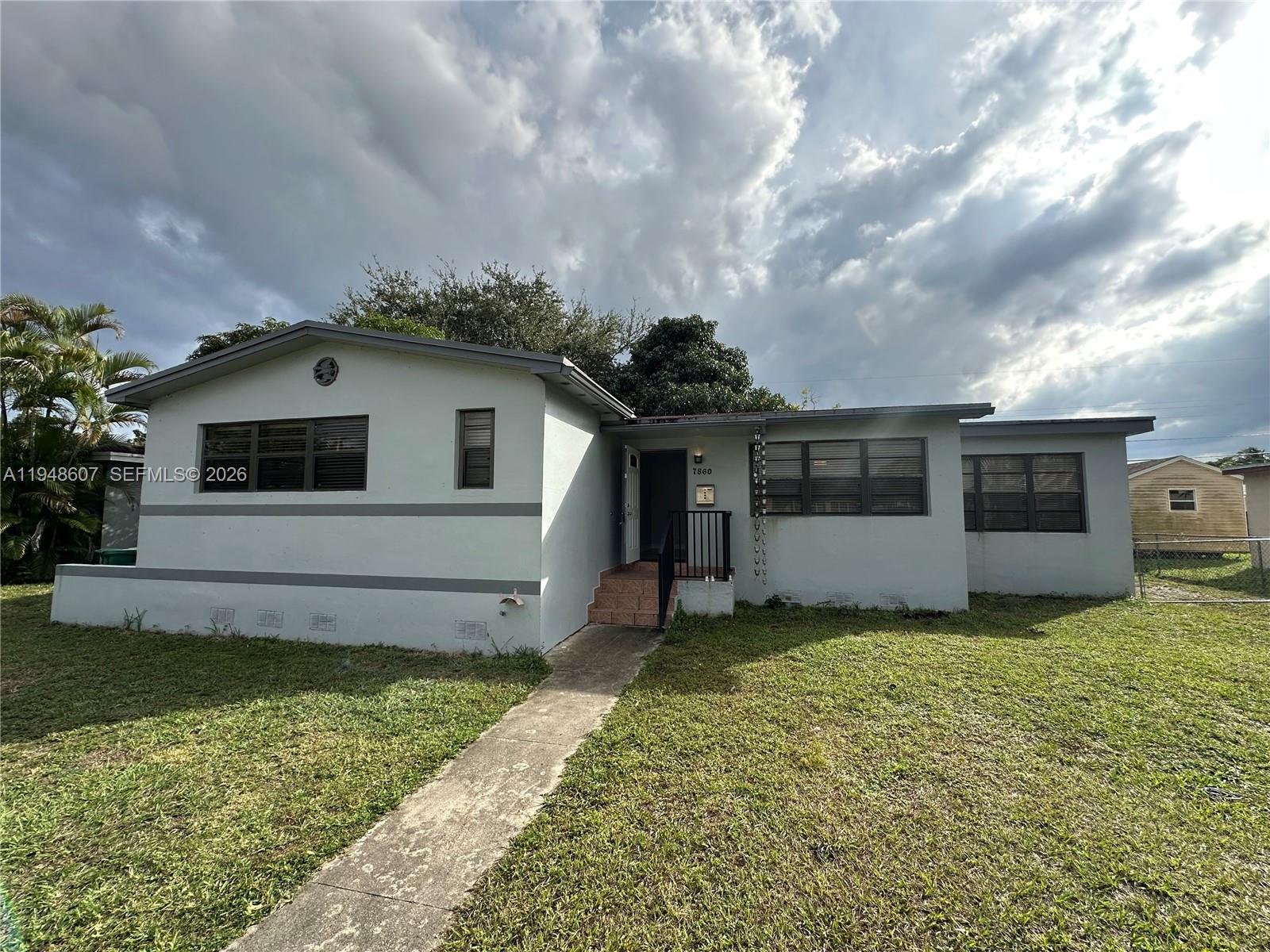 7860 Southwest 16th Street Miami, FL 33155 - Photo 2 of 32 a front view of house with yard