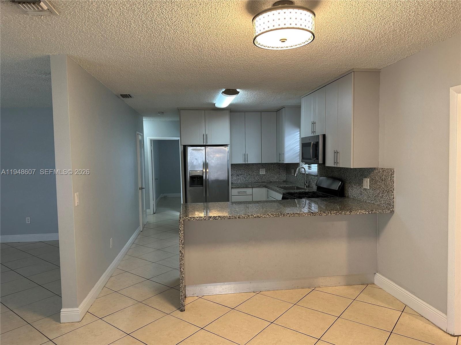 7860 Southwest 16th Street Miami, FL 33155 - Photo 22 of 32 a view of a kitchen with a sink and cabinets