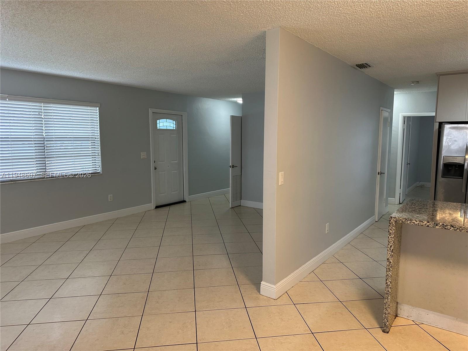 7860 Southwest 16th Street Miami, FL 33155 - Photo 23 of 32 a view of a livingroom with an empty space and a window