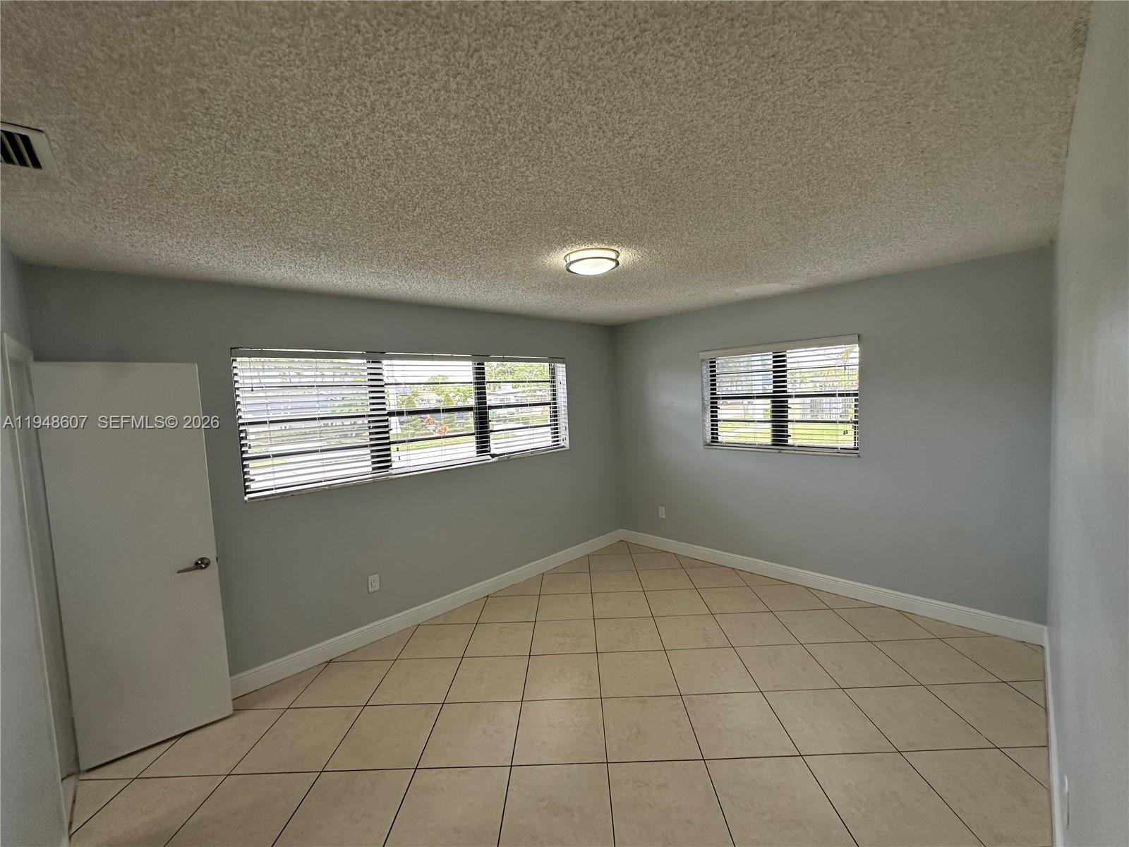 7860 Southwest 16th Street Miami, FL 33155 - Photo 10 of 32 a view of an empty room and window