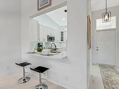 a kitchen with cabinets stainless steel appliances and a counter space