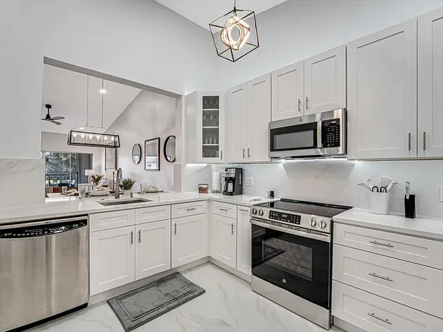 a kitchen with cabinets stainless steel appliances and a counter space