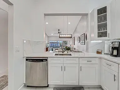 a kitchen with stainless steel appliances granite countertop a sink and cabinets