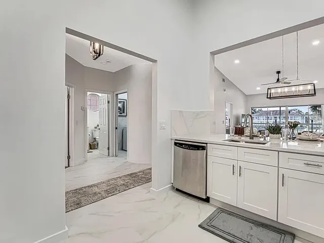 a white refrigerator freezer and a stove in a kitchen