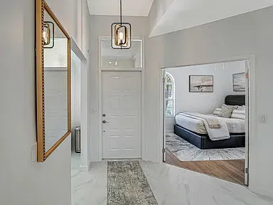 a bedroom with a large bed and a window