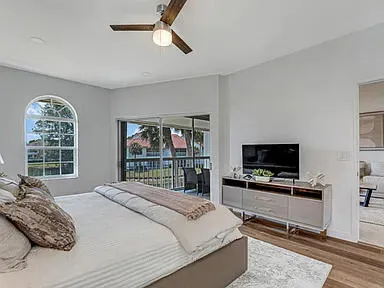 a bedroom with a large bed and a chandelier