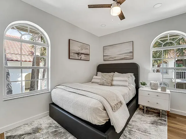 a bedroom with a bed and a window